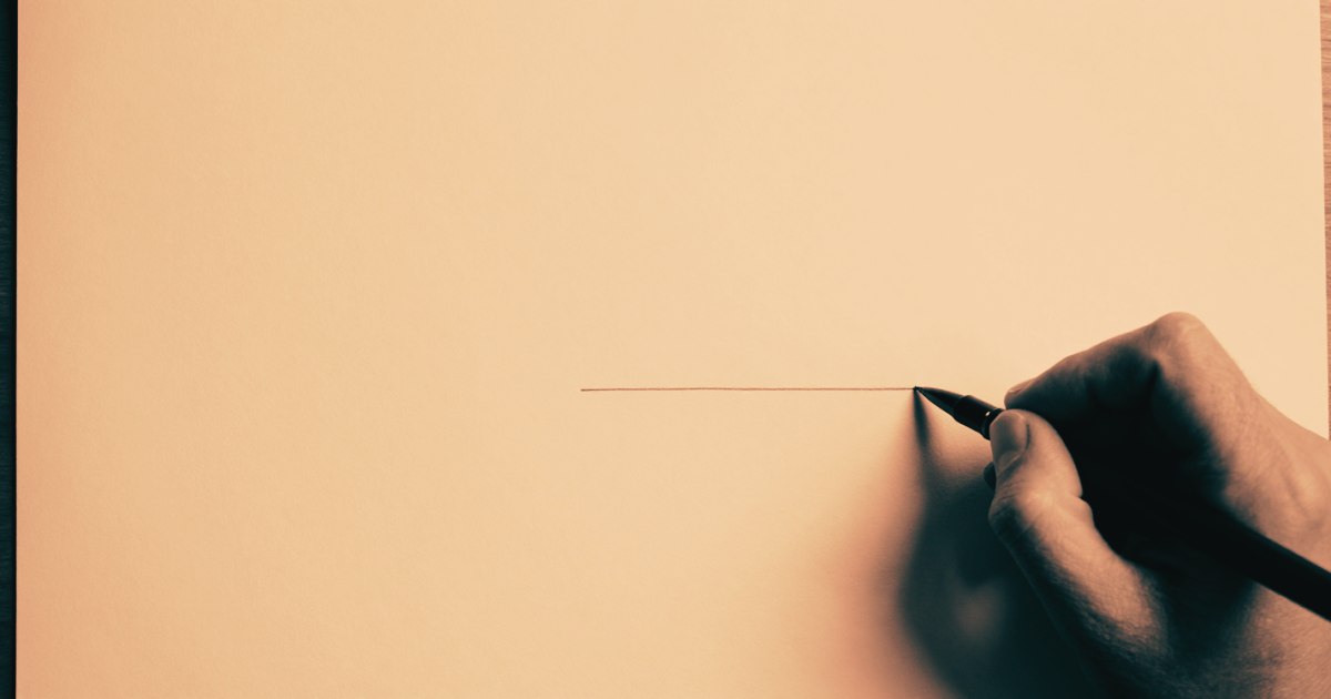 A hand drawing a single precise line on a large blank technical drawing, shot from above